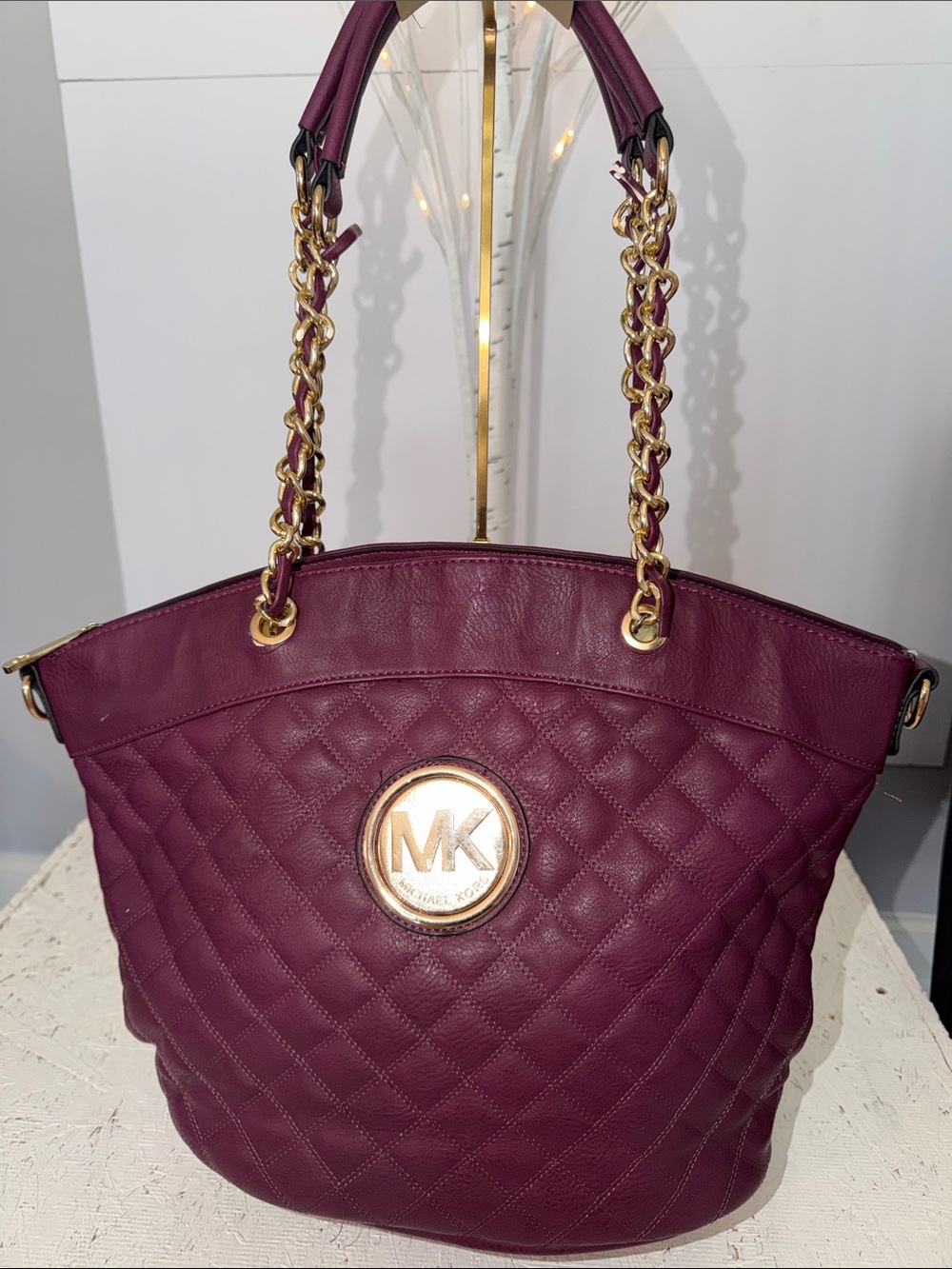 MK purple quilted canvas shoulder bag with gold tone hardware. 15 by 10”